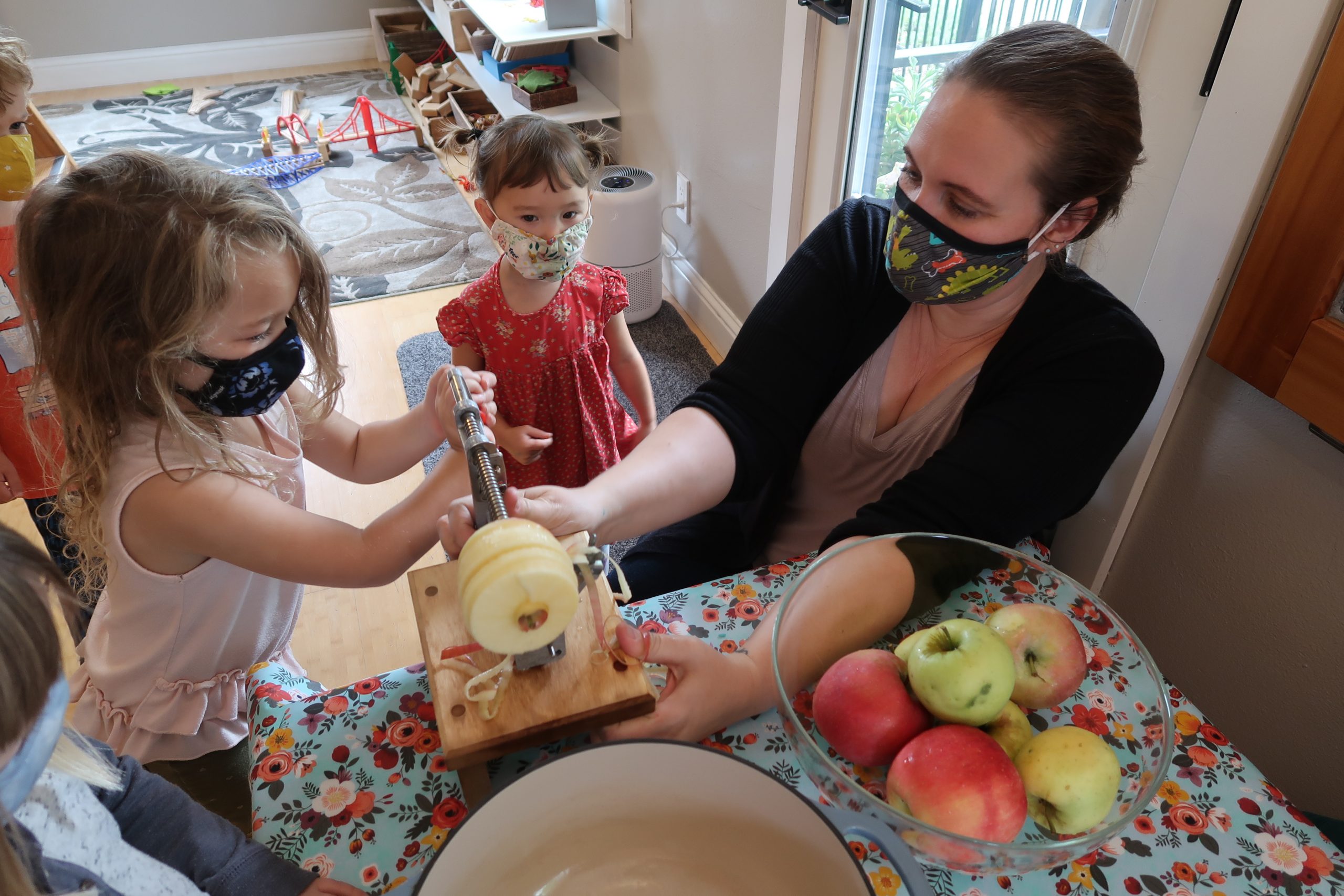 Kids spiral cutting apples.